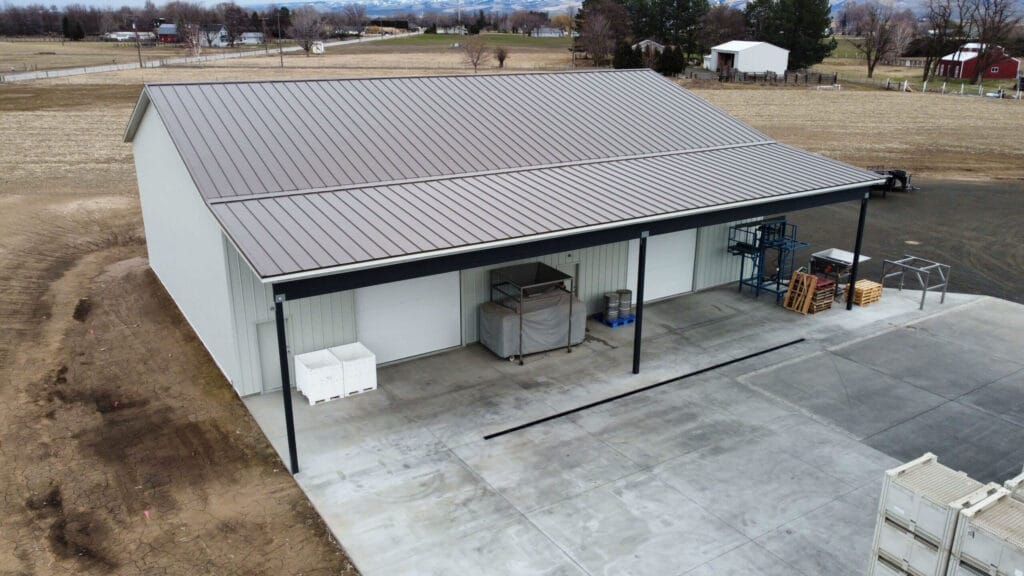 Rural storage building with metal roof and crates.