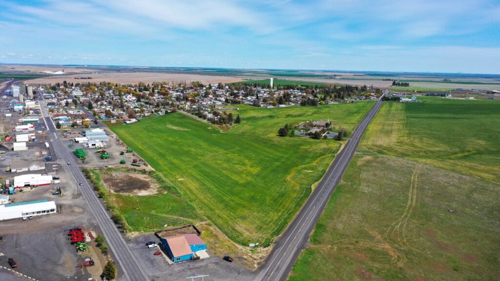 Aerial view of small town and green fields.