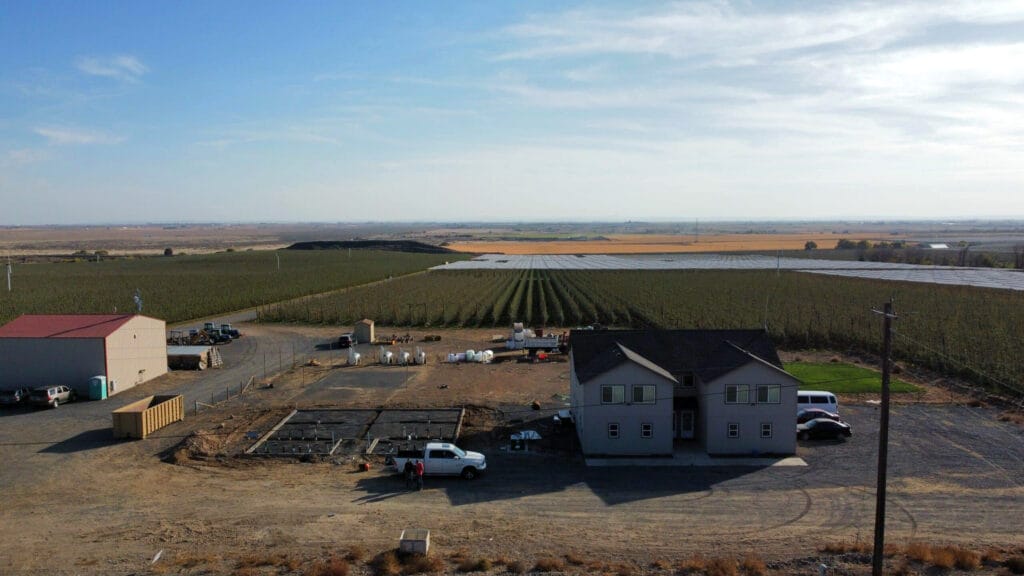Aerial view of farm buildings and fields.