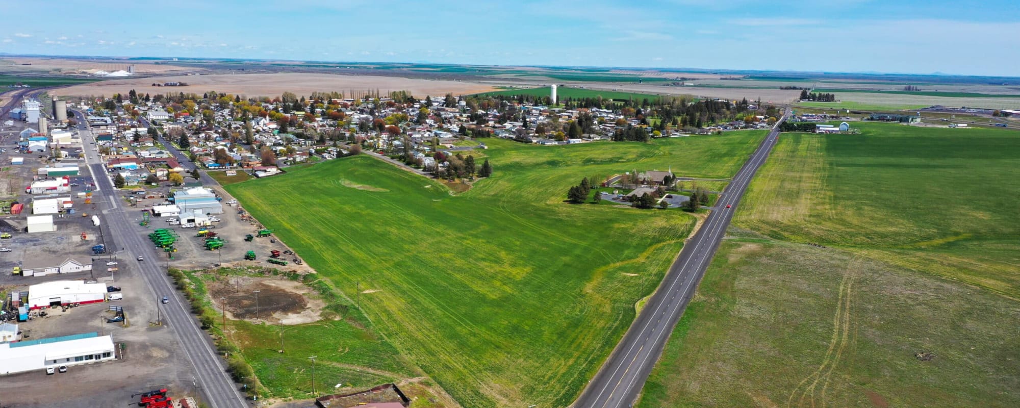 Aerial view of green fields and rural town