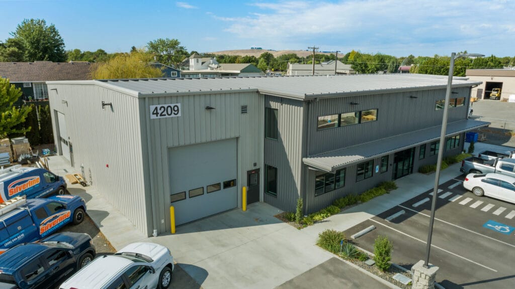 Industrial building with parking area and company vans.
