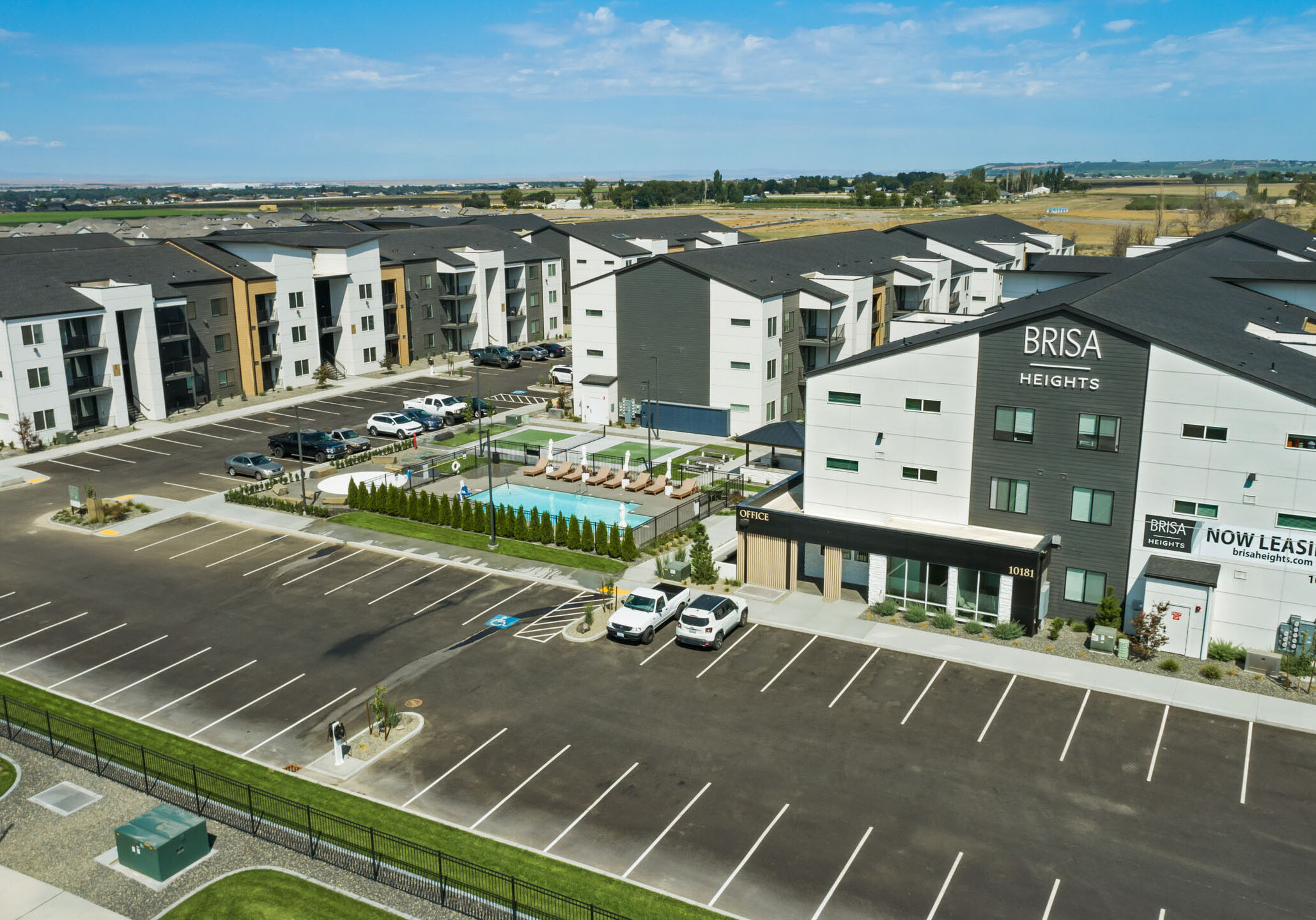 Brisa Heights apartment complex with parking and pool.