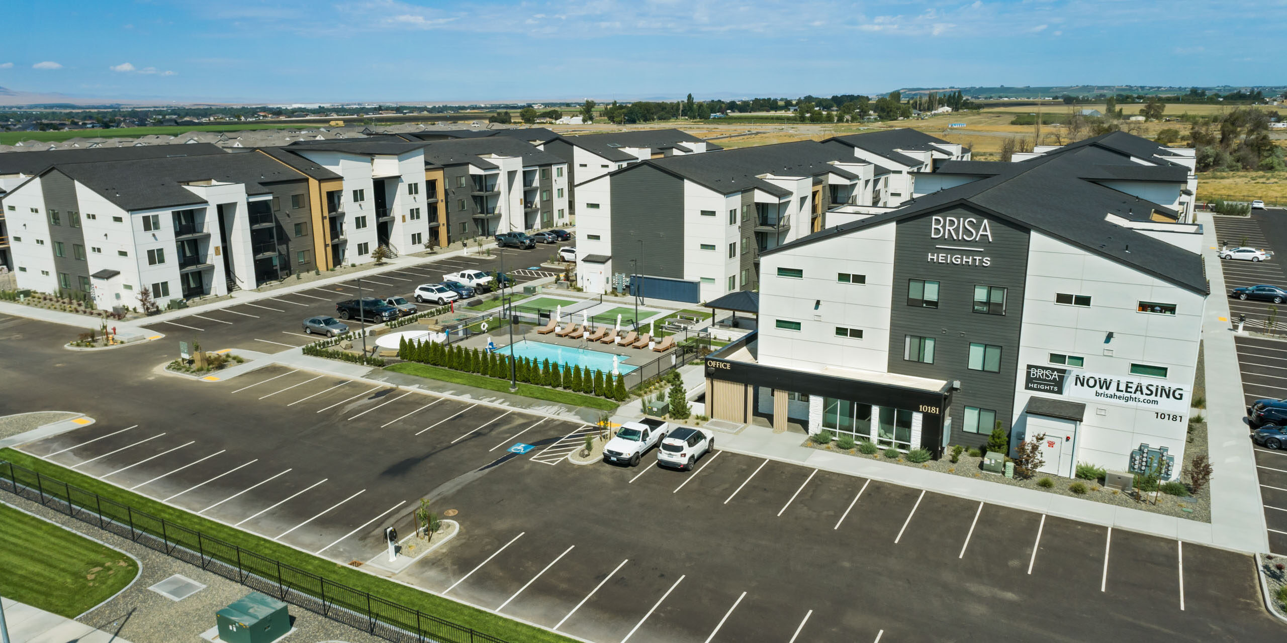 Brisa Heights apartment complex with parking and pool.
