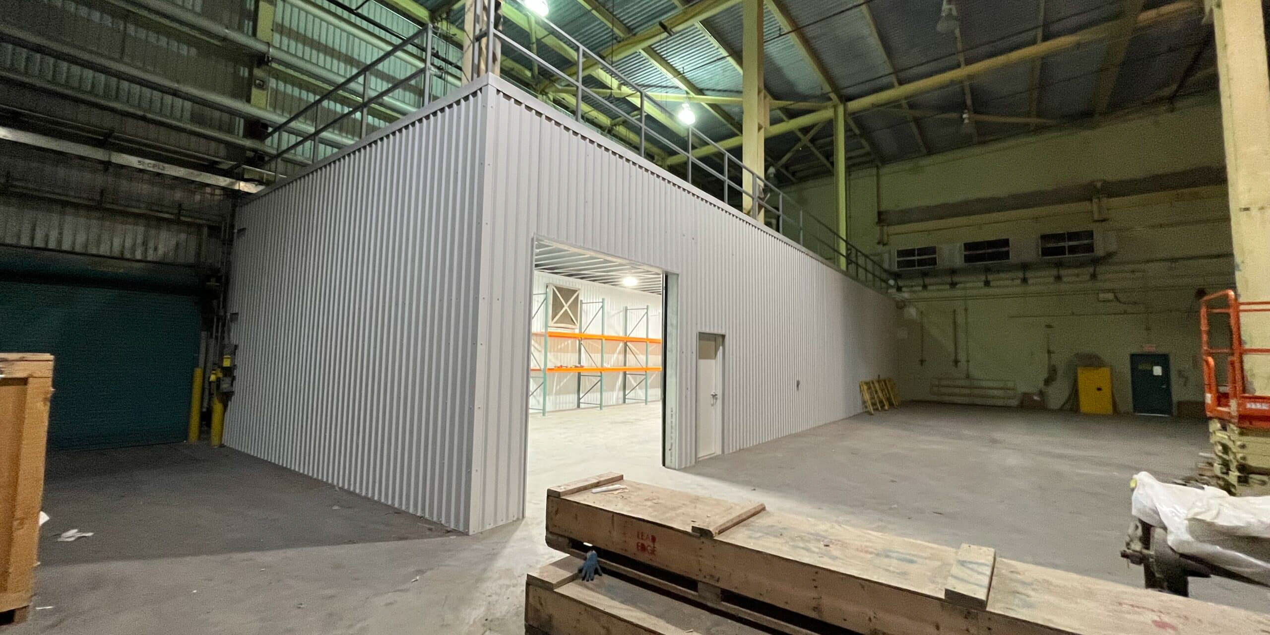 Empty industrial warehouse interior with metal partition