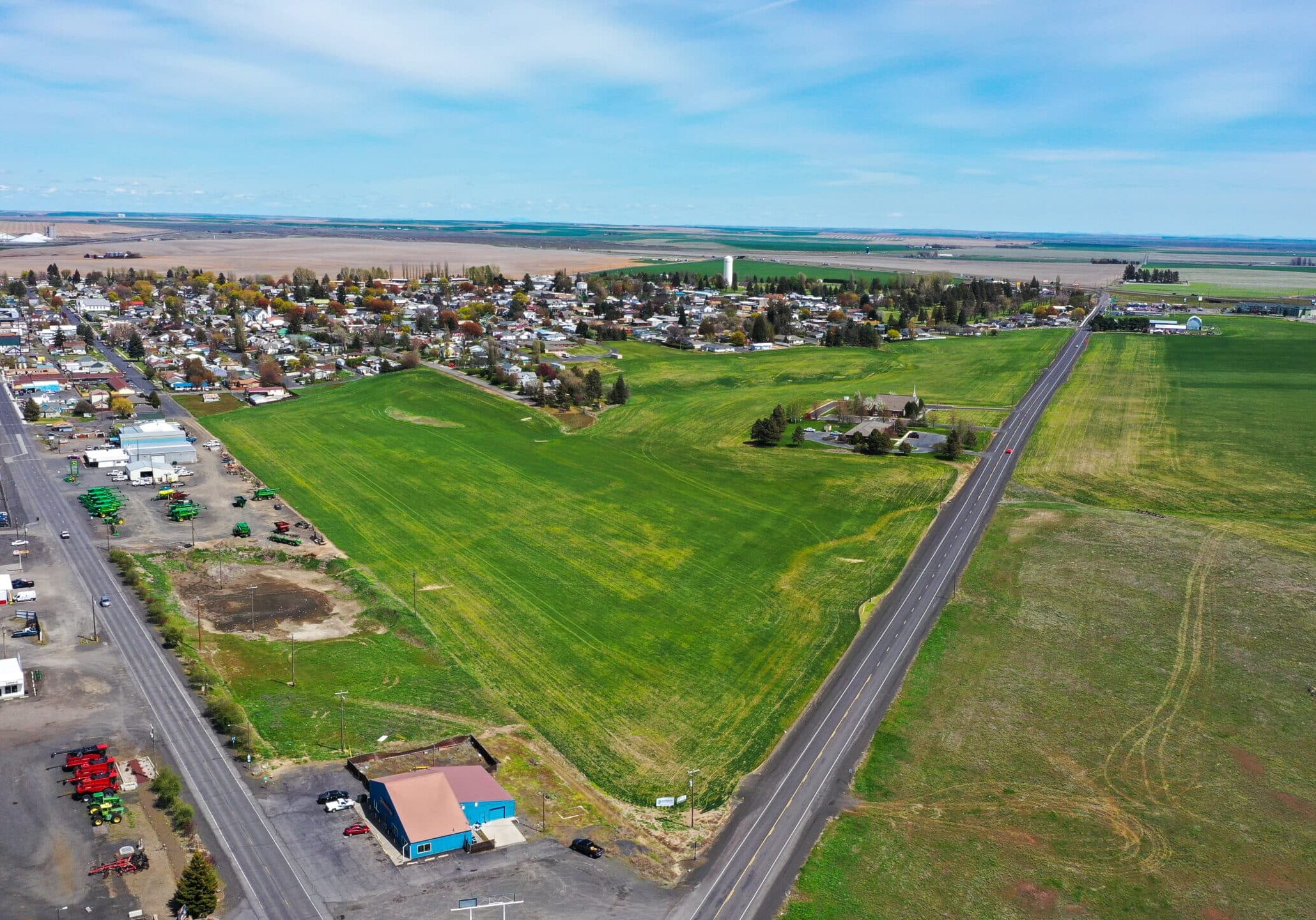 Aerial view of small town and green fields.