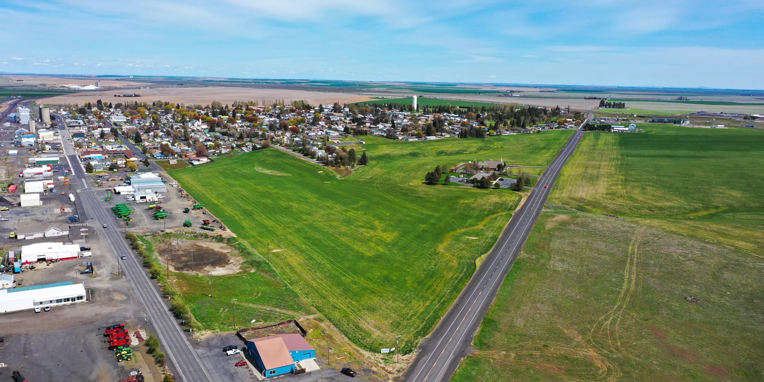 Aerial view of small town and green fields.