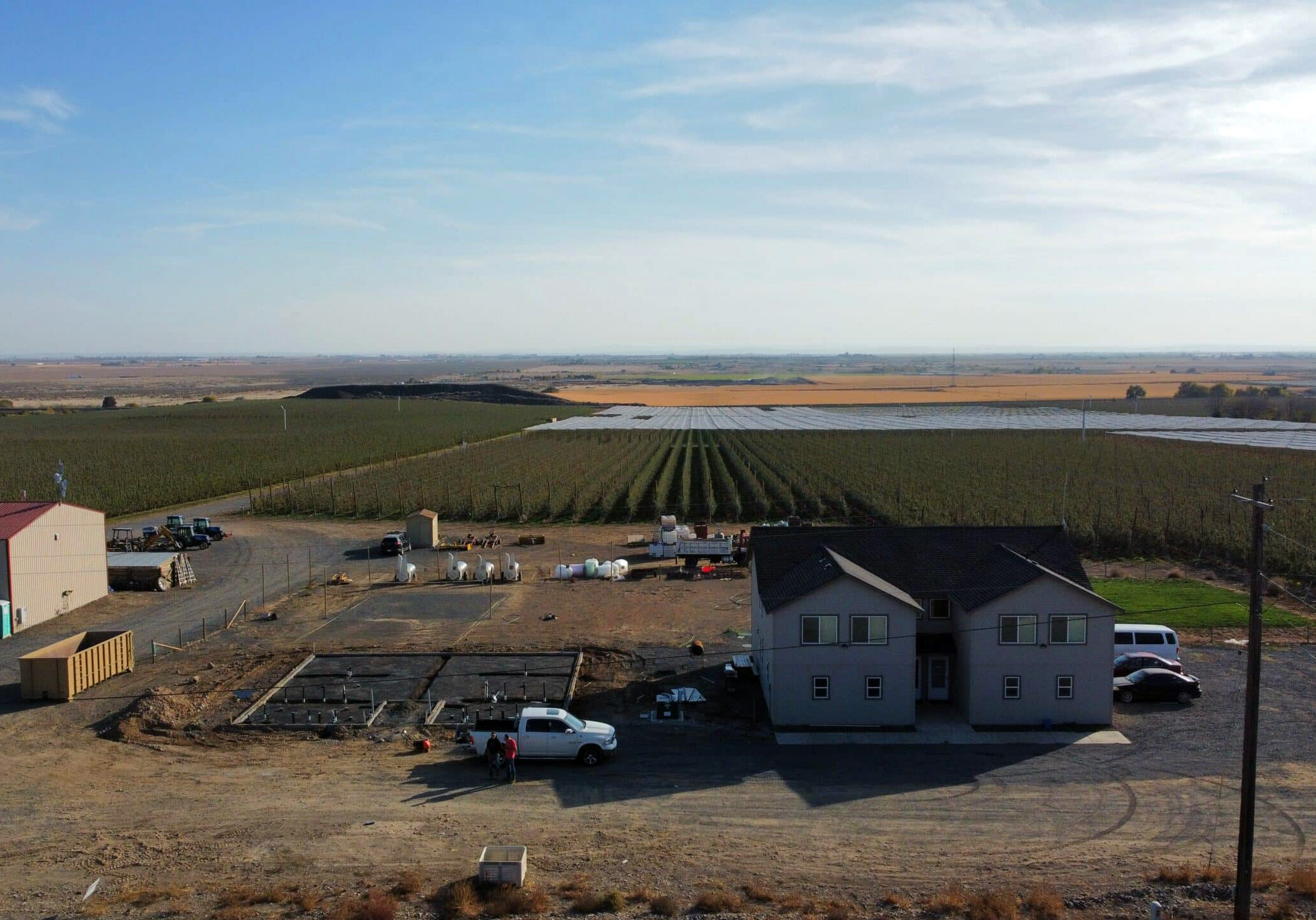 Aerial view of farm buildings and fields.
