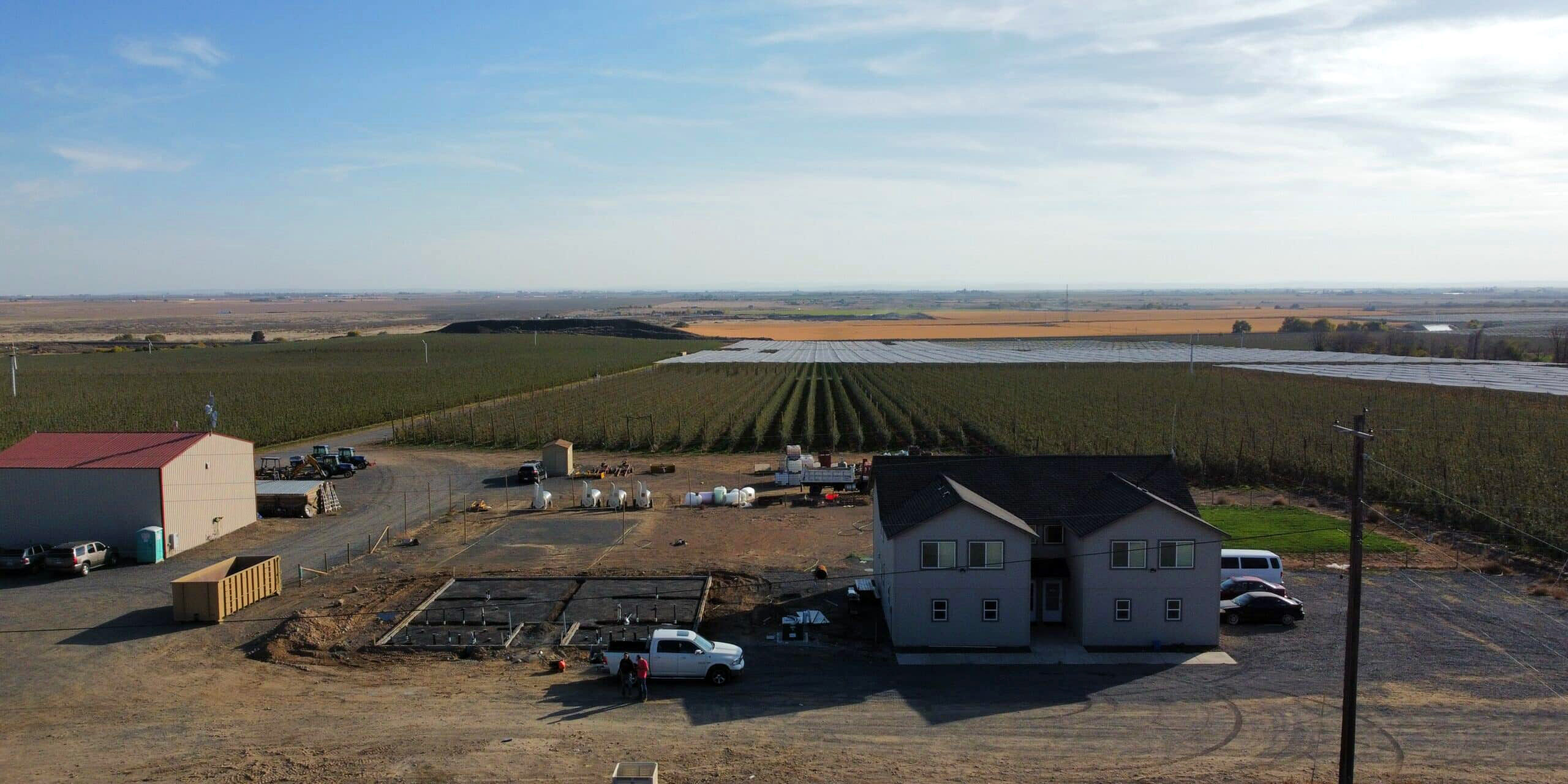 Aerial view of farm buildings and fields.