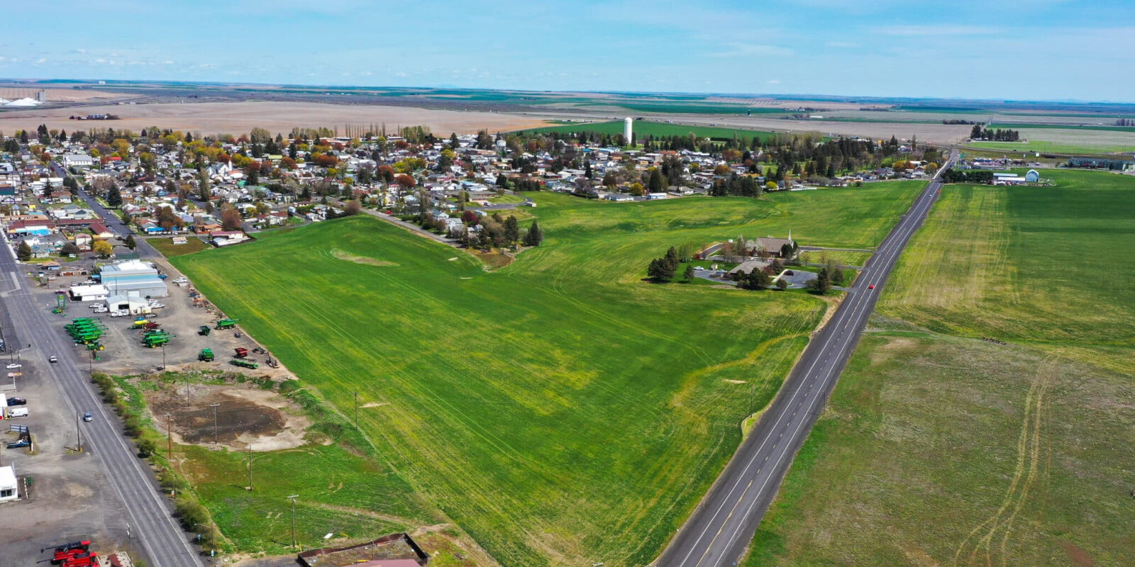 Aerial view of green fields and rural town